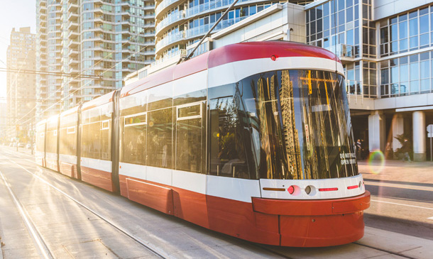 Photo of a passenger rail train in a city.