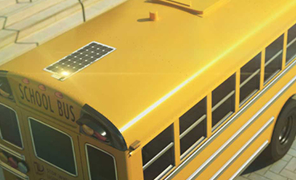 Photo showing a School Bus with a solar panel