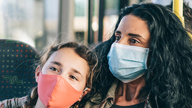 two passengers riding a bus with masks on benefiting from Thermo King Air Filters