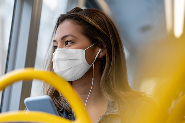 person on a bus with a mask